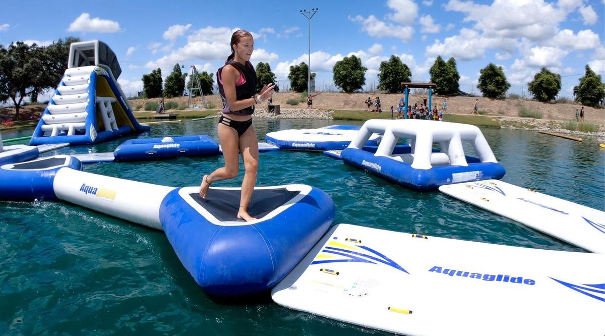 Kids and families climbing on the 30,000 square foot floating obstacle course at Velocity Island Park