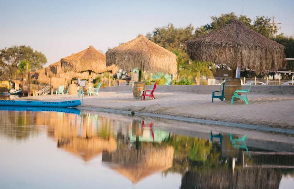 Private beach site with palapa shade structure at Velocity Island Park