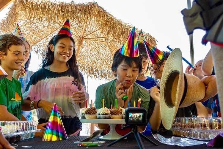 Birthday cake with candles at a Velocity Island Park celebration